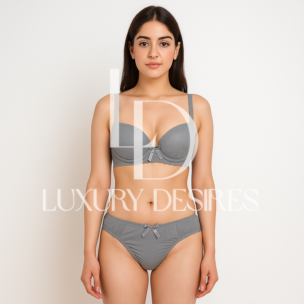 gray bra and panties set with 'Luxury Desires' branding.